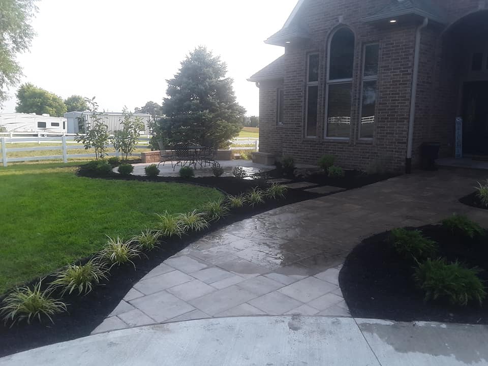 A paver pathway from driveway to door.