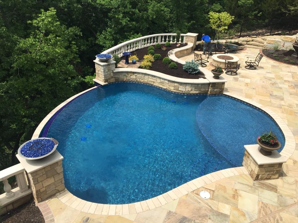 A pool with a stone deck.