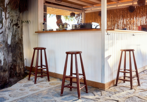 bar stools beside an outdoor bar