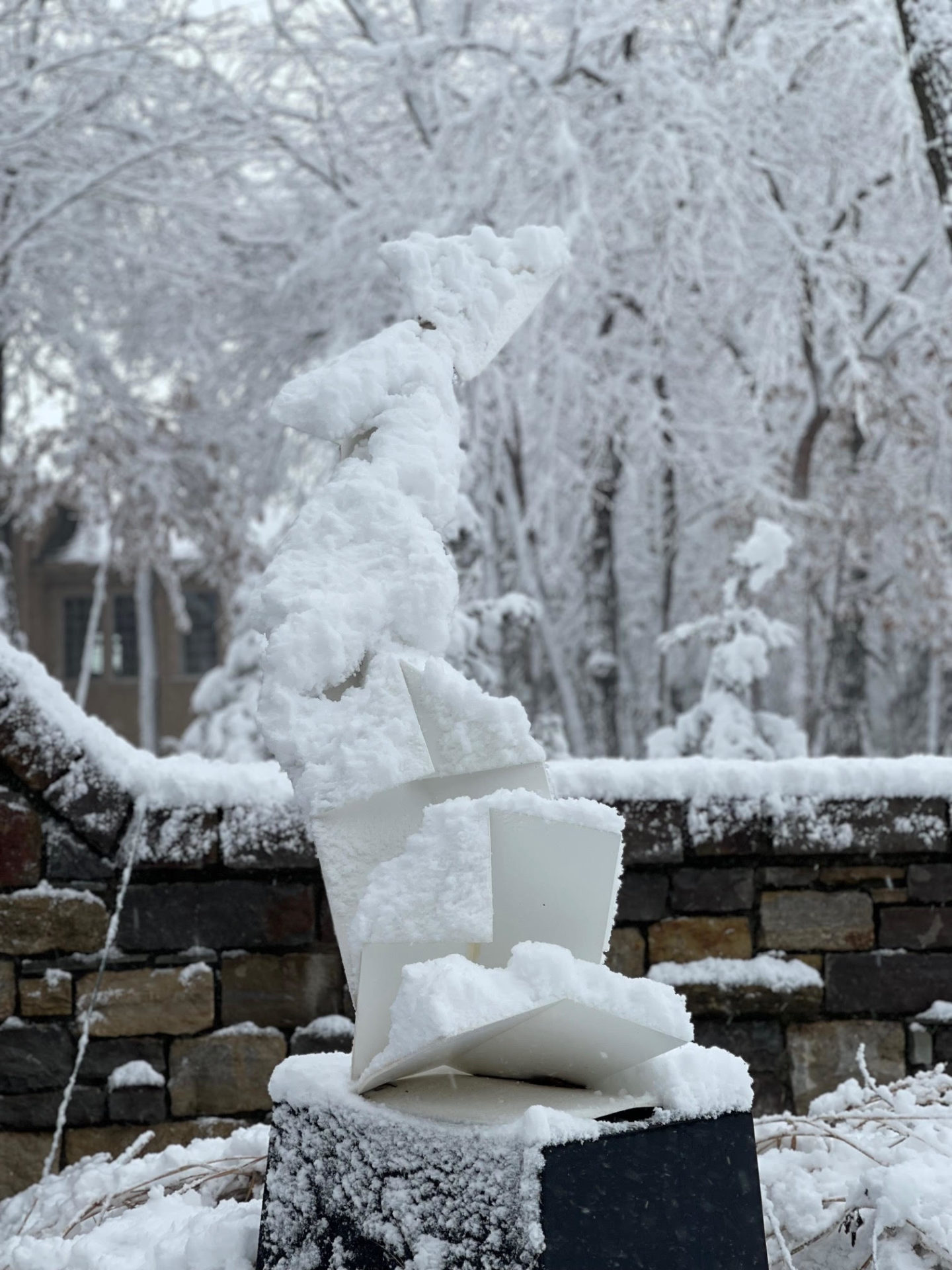 A snow covered sculpture in a garden