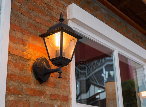 Porch light installed on red brick home