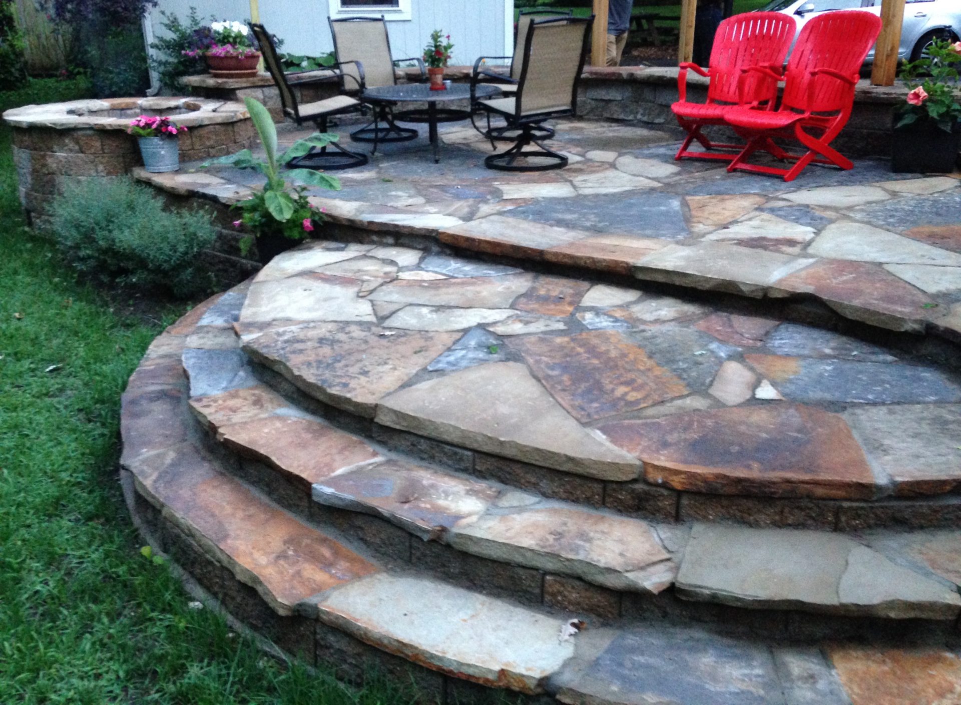 A patio and steps made up of colorful paver stones.