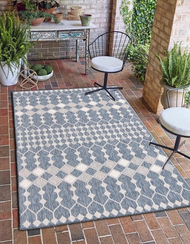 A pretty rug on a patio.