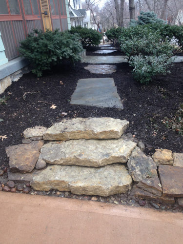 large paver stones cross a flower bed